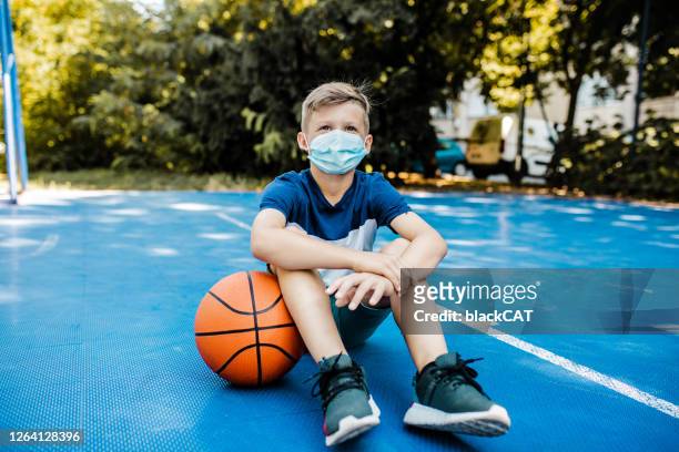 boy on the basketball field wearing a mask - serbia covid stock pictures, royalty-free photos & images