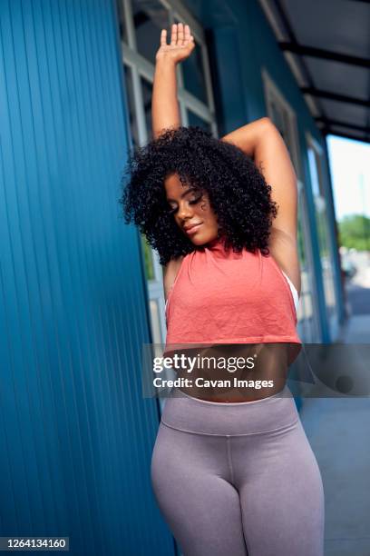 young woman in athleisure clothing - voluptuous stock pictures, royalty-free photos & images