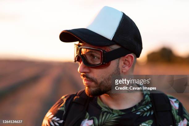 man with aviator glasses in nature, concept of starting a new adventure - beard pilot stock pictures, royalty-free photos & images