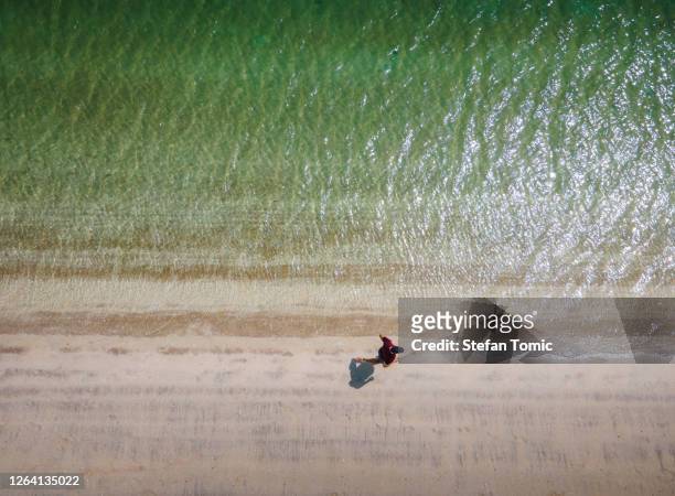 man running on the beach aerial view with copy space - runner sunrise stock pictures, royalty-free photos & images