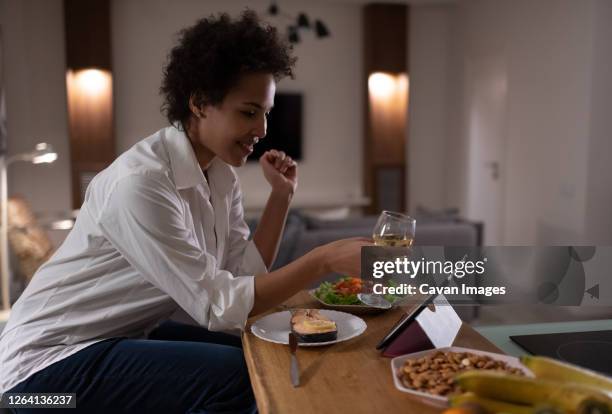 happy mixed race woman proposing toast during online date - virtual dinner stock pictures, royalty-free photos & images