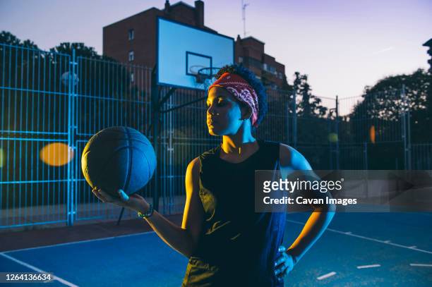 latin and african women play basketball - street basketball stockfoto's en -beelden