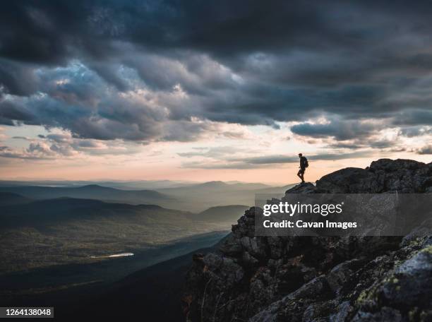 lone hiker on mountain summit appalachian trail at sunset, maine. - hiking appalachian trail stock pictures, royalty-free photos & images