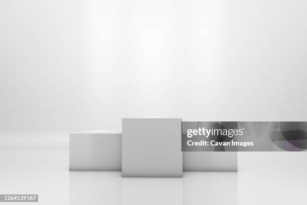 winning podium on white illuminated background - siegertreppe stock-fotos und bilder