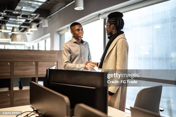 colleagues shaking hands in the office - depigmentation stock pictures, royalty-free photos & images