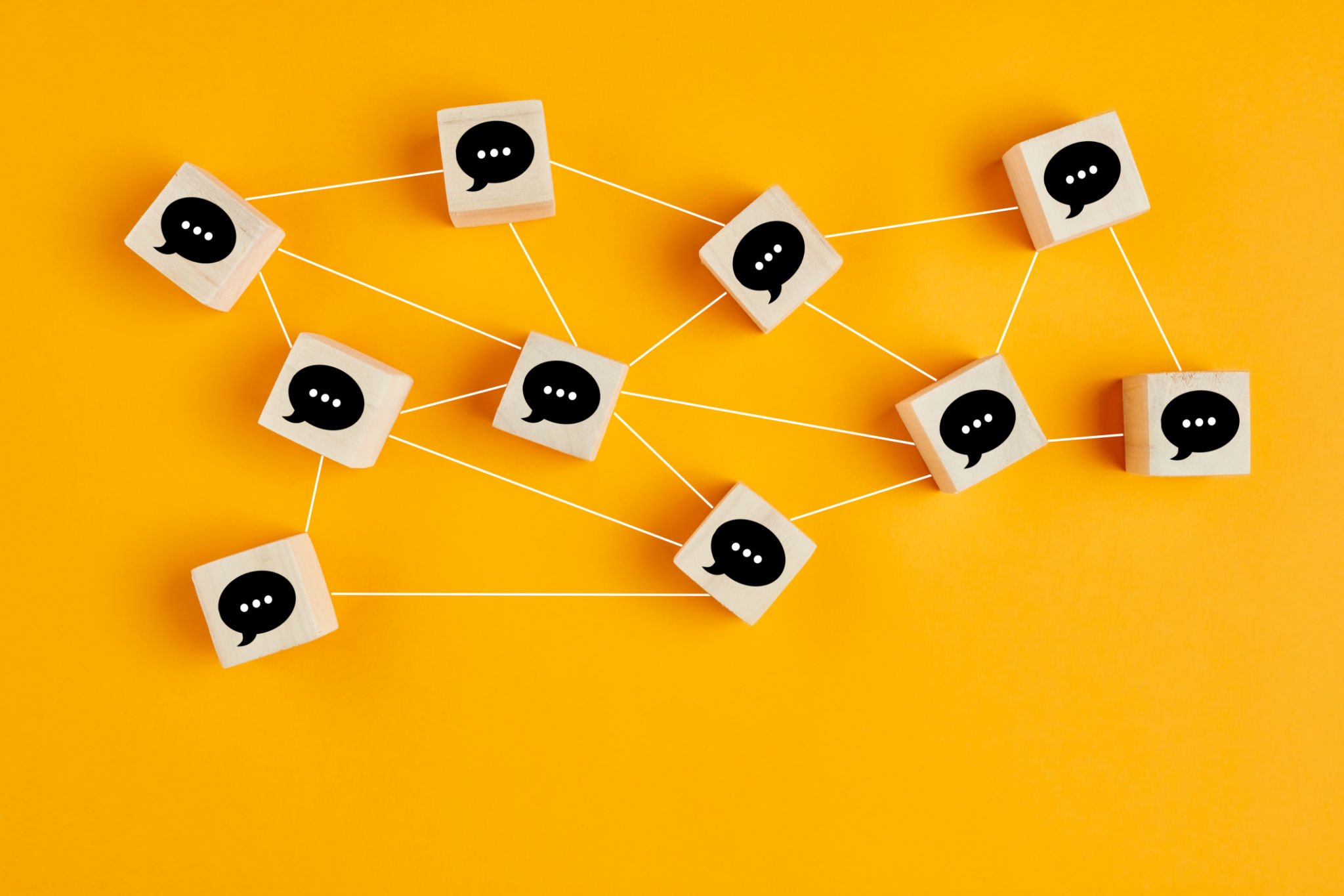 Concept of online communication or social networking. Wooden cubes with speech bubbles linked to each other. Concept of online communication or social networking. Wooden cubes with speech bubbles linked to each other.