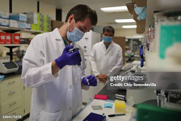 Lab Technician Carter Tavaglione prepares a solution that will be used to process coronavirus test samples at Advagenix, a molecular diagnostics...