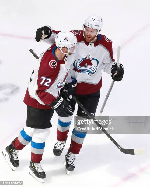 Joonas Donskoi of the Colorado Avalanche is congratulated by teammate J.T. Compher after he scored a goal in the first period against the Dallas...