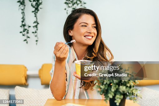 Happy young woman enjoying in rolled ice cream Happy young woman enjoying in rolled ice cream