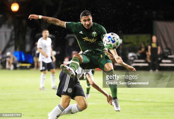 Marvin Loria of Portland Timbers competes for the ball against Jack Elliott of Philadelphia Union in the first half during the MLS Is Back Tournament...