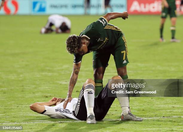 Alejandro Bedoya of Philadelphia Union reacts after being defeated by the Portland Timbers 2-1 as Andy Polo of Portland Timbers comforts him in the...