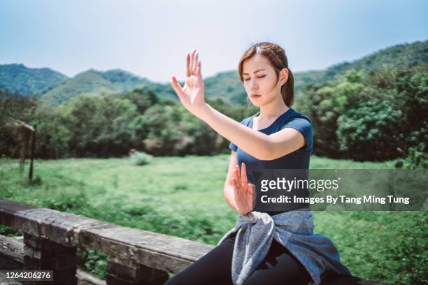 portrait of young asian woman practicing kung fu in rural area - woman and tai chi stock pictures, royalty-free photos & images