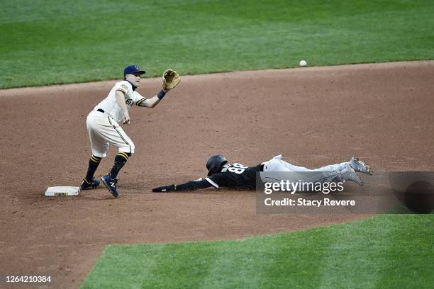 Luis Robert of the Chicago White Sox beats a tag at second base by Brock Holt of the Milwaukee Brewers during a game at Miller Park on August 04,...