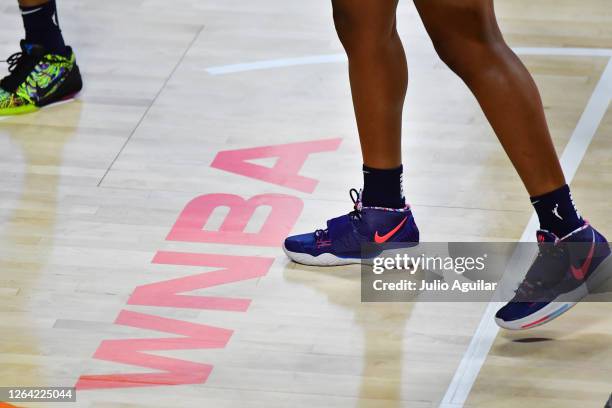 Stephanie Mavunga of the Indiana Fever stands near the WNBA logo during a game against the Atlanta Dream at Feld Entertainment Center on August 02,...