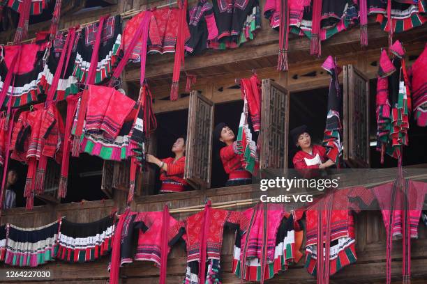 Yao women hang traditional costumes out to dry in the sun at Dazhai village on July 30, 2020 in Longsheng County, Guangxi Zhuang Autonomous Region of...