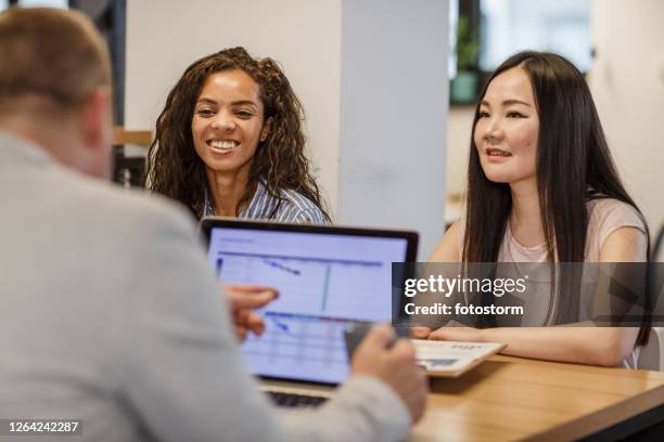 multicultural office colleagues in a board room - hub stock pictures, royalty-free photos & images