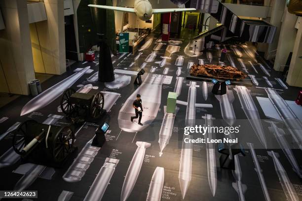 Man walsk across "The History of Bombs" by Ai Weiwei following the first screening of the commissioned video installation "I Saw The World End", at...