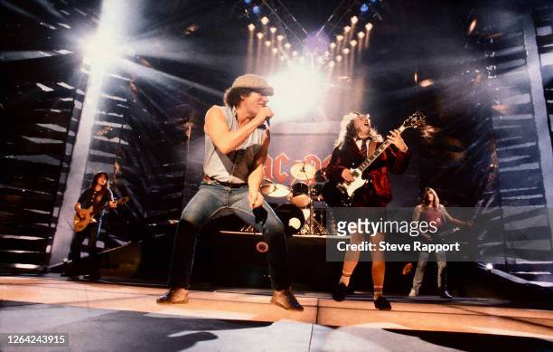 Brian Johnson and Angus Young, both of the group AC/DC, film the 'Thunderstruck' music video, Brixton Academy, London, 8/17/1990.