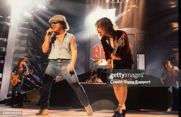 Brian Johnson and Angus Young, both of the group AC/DC, film the 'Thunderstruck' music video, Brixton Academy, London, 8/17/1990.