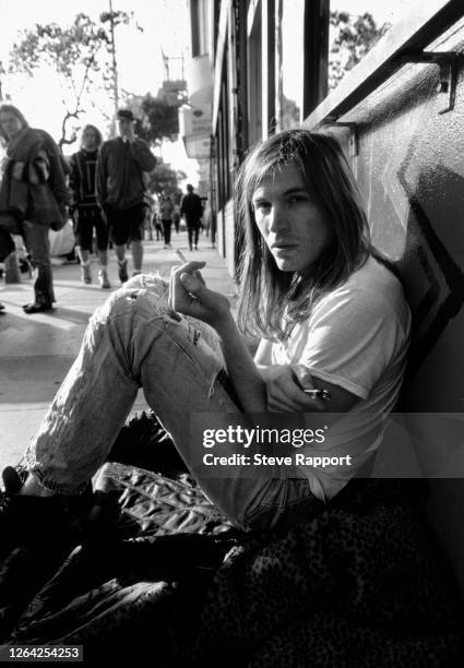 American Alternative Rock musician Evan Dando, of the group Lemonheads, sits on the sidewalk on Haight Street, in the Haight Ashbury neighborhood,...