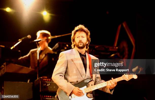 English Blues musician Eric Clapton performs onstage during Nelson Mandela's 70th birthday tribute concert at Wembley Stadium, London, 6/11/1988.