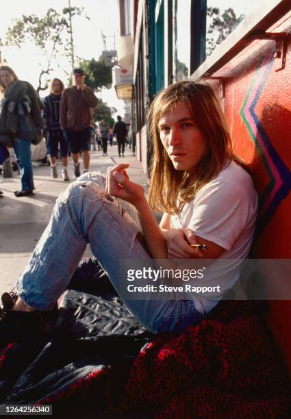 American Alternative Rock musician Evan Dando, of the group Lemonheads, sits on the sidewalk on Haight Street, in the Haight Ashbury neighborhood,...