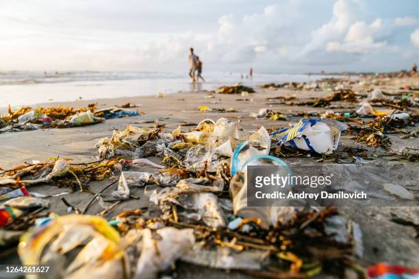 bali, plastic pollution on kuta beach. - plastic pollution stock pictures, royalty-free photos & images