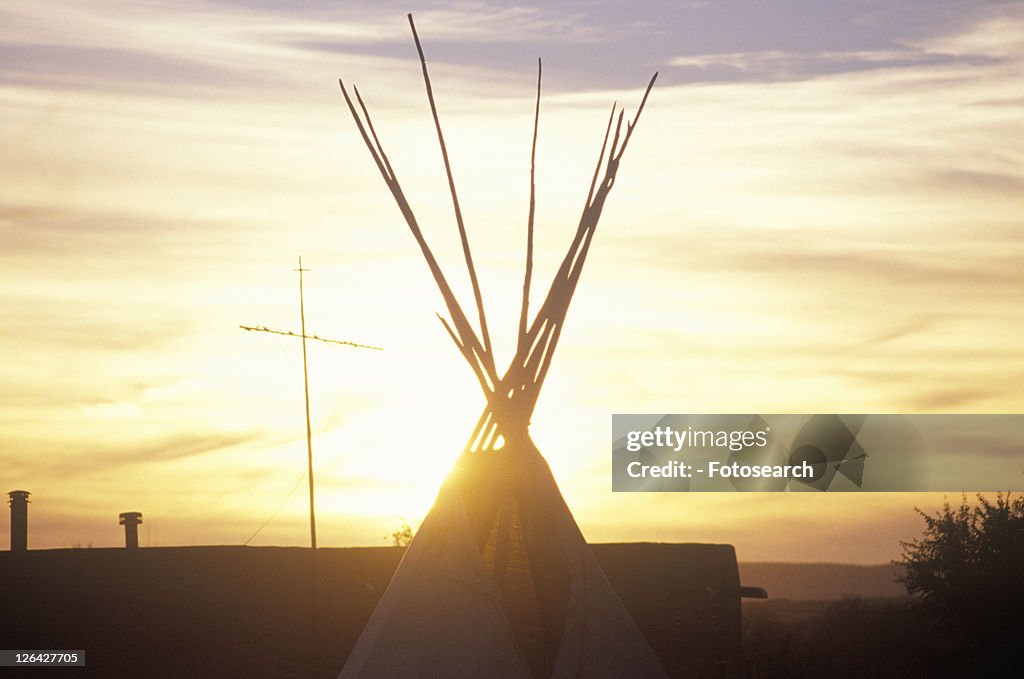 Teepee and cross silhouette on Indian reservation