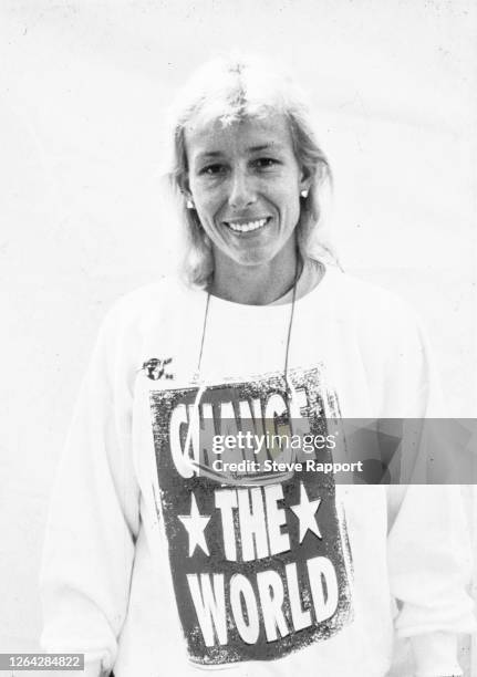 Portrait of Czech tennis player Martina Navratilova dressed in a sweatshirt that reads 'Change The World,' 4/17/1986.