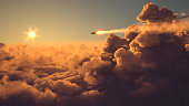 Missile fly above the clouds at sunset