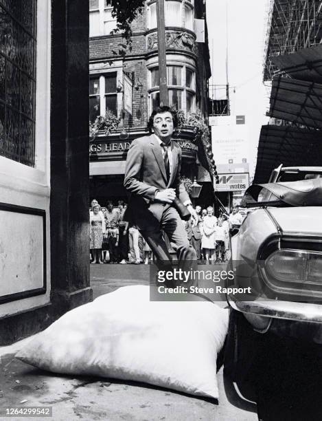 English comedian and actor Rowan Atkinson films 'Dead On Time' outside The White Lion on Floral Street , Covent Garden, London, 8/4/1981.