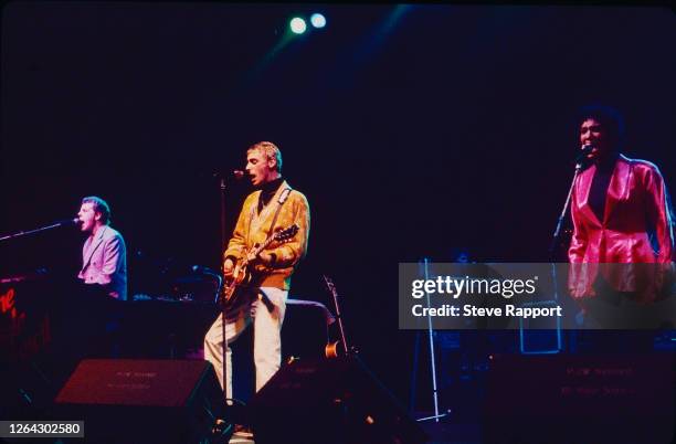 View of, from left, English musicians Mick Talbot, Paul Weller, and Dee C Lee, all of the group the Style Council, Red Wedge Tour, Manchester Apollo,...