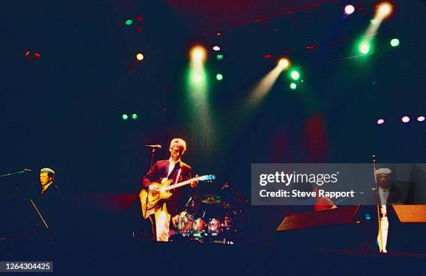 View of from, fore from left, English Pop and Rock musicians Mick Talbot, Paul Weller and Dee C Lee, all of the group the Style Council, as they...