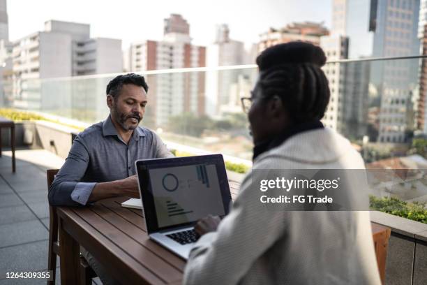 coworkers doing a meeting / interview at office rooftop - candidate experience stock pictures, royalty-free photos & images