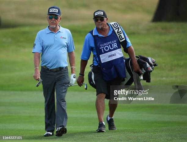 Miguel Angel Jimenez of Spain walks down the 18th hole with caddie Kyle Roadley during Day One of the English Championship at Hanbury Manor Marriott...