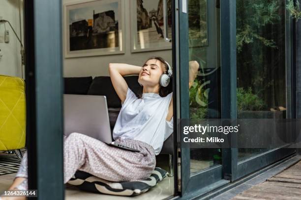 relaxing at home with music and laptop - radio listening stock pictures, royalty-free photos & images