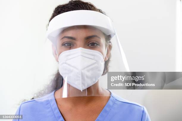 female doctor wears ppe in covid-19 unit - ppe stock pictures, royalty-free photos & images