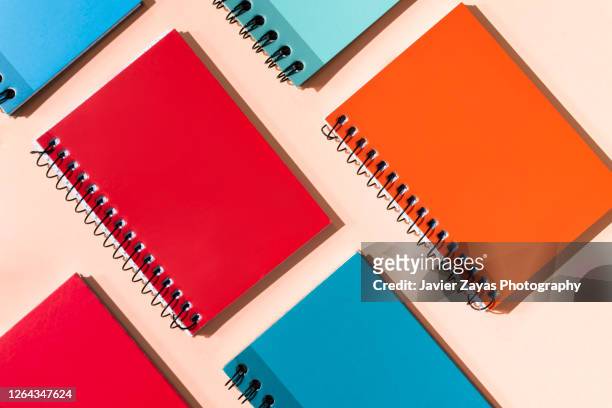 many colorful notepads on a pastel background - blank book on desk stock-fotos und bilder