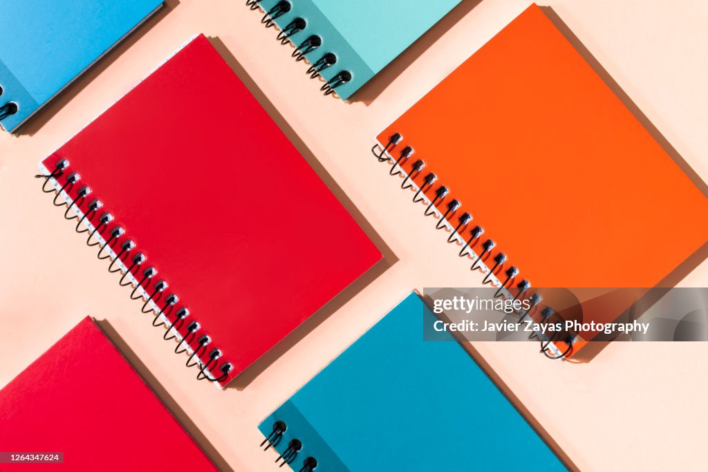 Many Colorful Notepads On A Pastel Background
