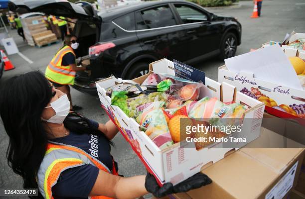 Boxes of food are distributed by the Los Angeles Regional Food Bank to people facing economic or food insecurity amid the COVID-19 pandemic on August...