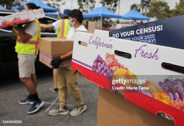 Pamphlet with 2020 census information is included in a box of food to be distributed by the Los Angeles Regional Food Bank to people facing economic...