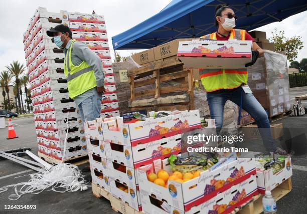 Boxes of food are prepared to be distributed by the Los Angeles Regional Food Bank to people facing economic or food insecurity amid the COVID-19...