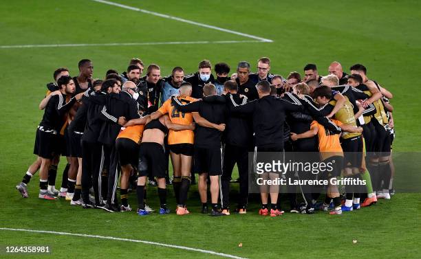 Wolves players gather to celebrate victory on the pitch after full-time during the UEFA Europa League round of 16 second leg match between...