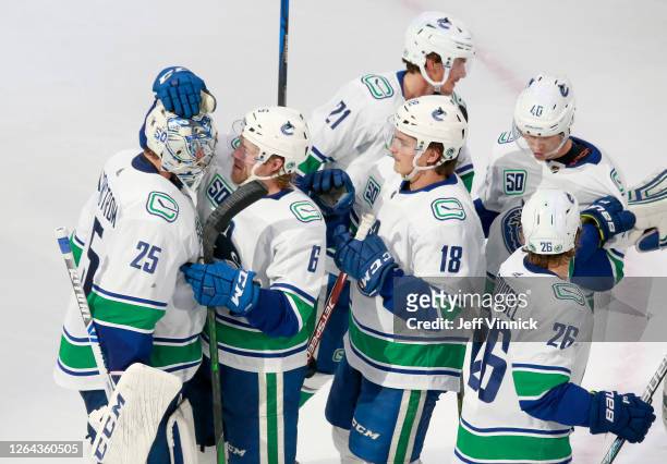 Jacob Markstrom of the Vancouver Canucks is congratulated by teammate Brock Boeser after Markstrom recorded his first career shutout with the 3-0 win...