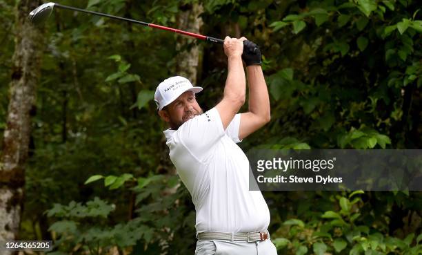Erik Compton hits his tee shot on the fourth hole during the first round of the WinCo Foods Portland Open on Pumpkin Ridge's Witch Hollow course on...