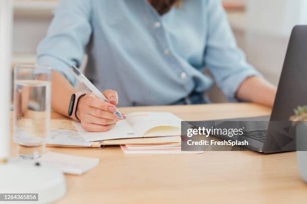 working from home: hand of a businesswoman writing notes - busy schedule stock pictures, royalty-free photos & images