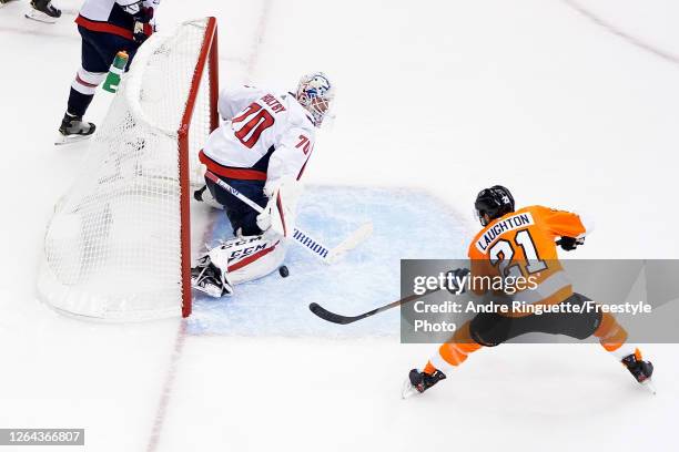 Scott Laughton of the Philadelphia Flyers scores a goal on Braden Holtby of the Washington Capitals during the third period in the Eastern Conference...