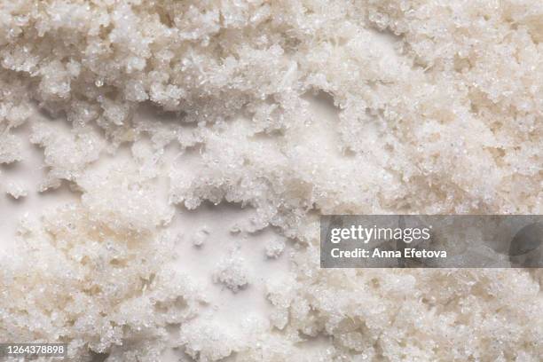 scrub with coconut flakes - salt mineral stock-fotos und bilder