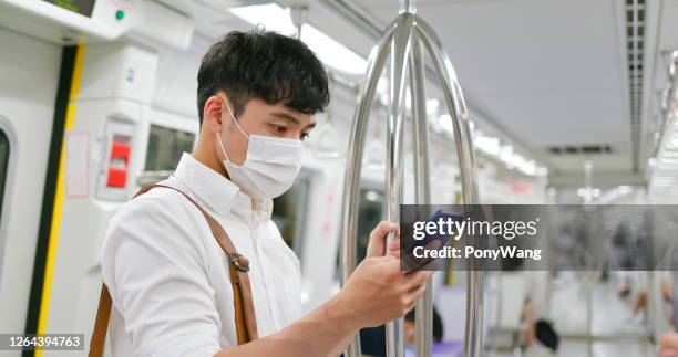 man with mask in metro - taipei mrt stock pictures, royalty-free photos & images