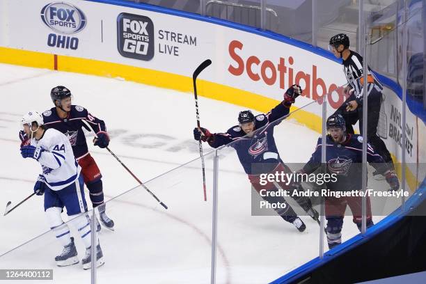 Pierre-Luc Dubois of the Columbus Blue Jackets is congratulated by his teammates Cam Atkinson and Alexandre Texier after scoring the game-winning...